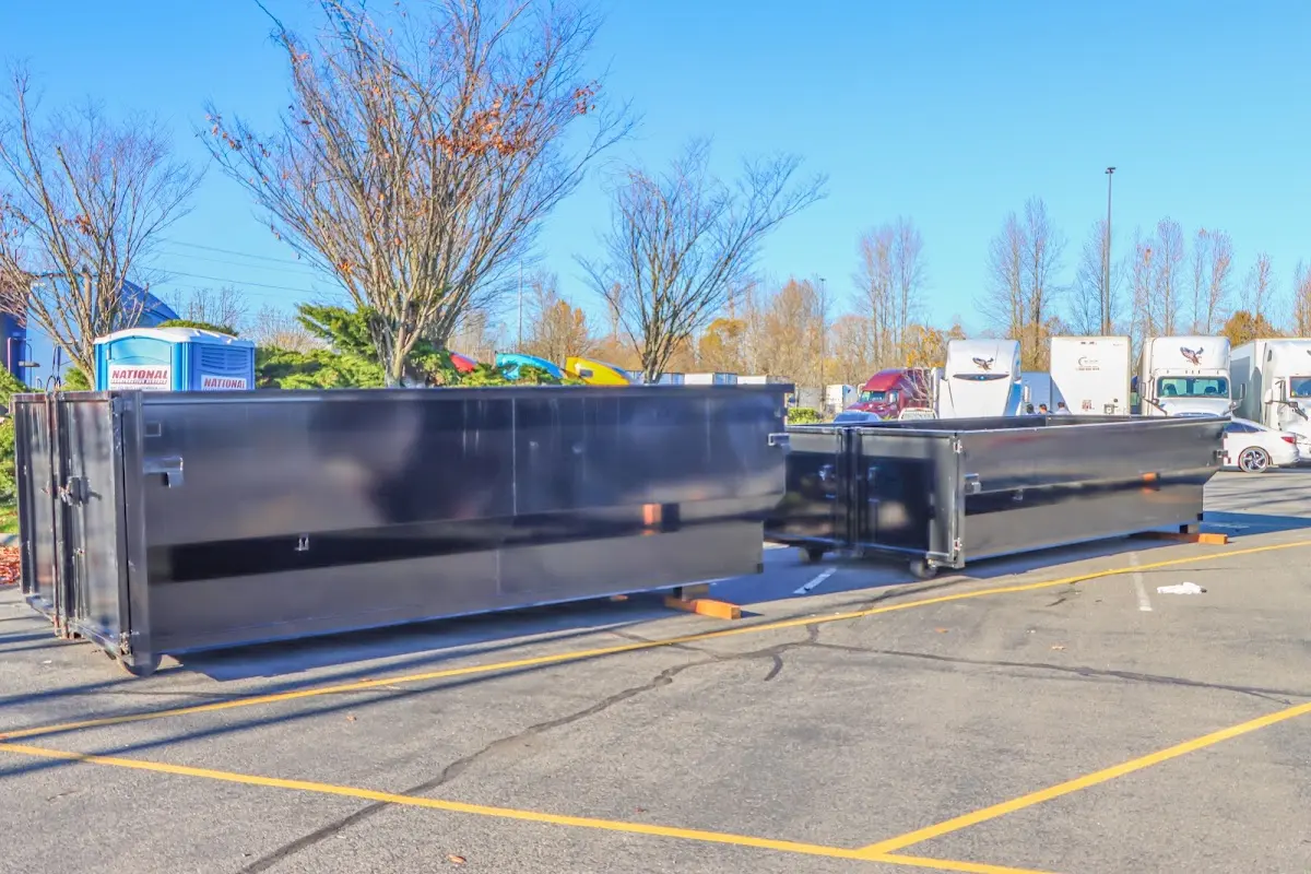 Professional dumpster rental service with roll-off container on residential driveway in South Strabane